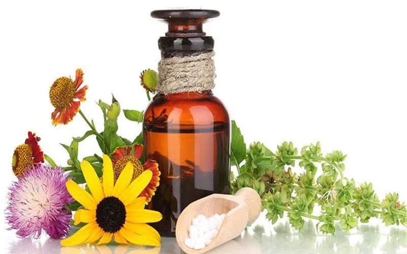 Un flaconcino con fiori e piante officinali